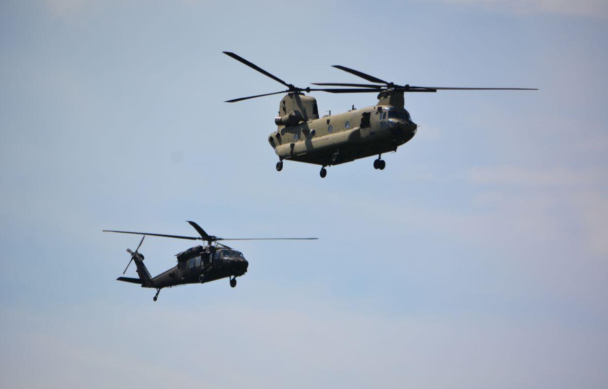 A Black Hawk and a Chinook helicopter from Fort Campbell conduct a flyover on April 13, 2023. (Lee Erwin)