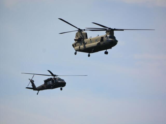 A Black Hawk and a Chinook helicopter from Fort Campbell conduct a flyover on April 13, 2023. (Lee Erwin)