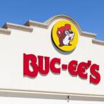 Buc-ee's storefront sign with bold red letters and a round yellow logo featuring a beaver wearing a red hat.
