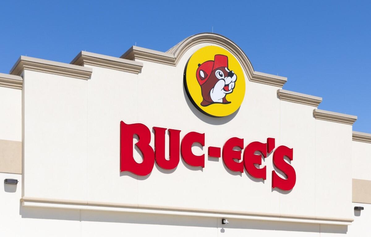 Buc-ee's storefront sign with bold red letters and a round yellow logo featuring a beaver wearing a red hat.
