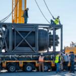Civilian contractors secure rigging to a containerized nuclear power reactor during staging operations at March Air Reserve Base, Calif., Feb. 13, 2026. (Air Force Staff Sgt. Monique Bright, contributed)
