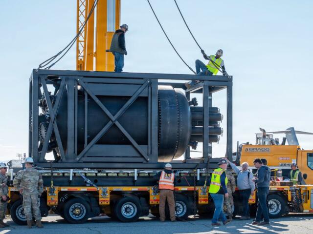 Civilian contractors secure rigging to a containerized nuclear power reactor during staging operations at March Air Reserve Base, Calif., Feb. 13, 2026. (Air Force Staff Sgt. Monique Bright, contributed)