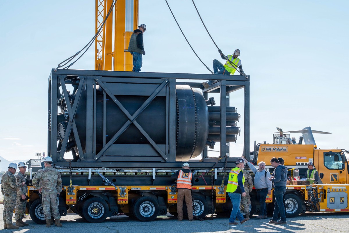 Civilian contractors secure rigging to a containerized nuclear power reactor during staging operations at March Air Reserve Base, Calif., Feb. 13, 2026. (Air Force Staff Sgt. Monique Bright, contributed)